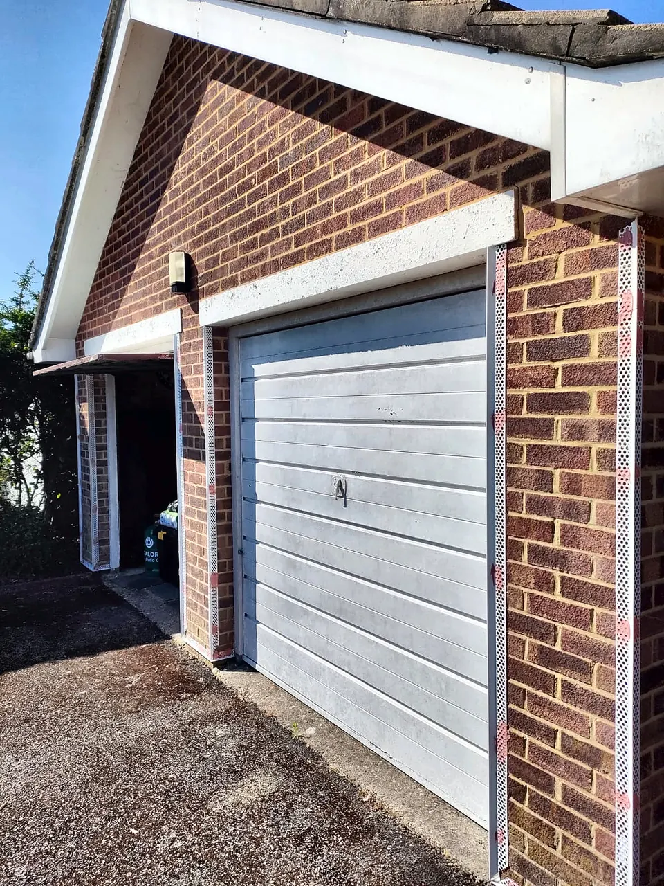 Brick garage front with corner beads fitted, ready for render