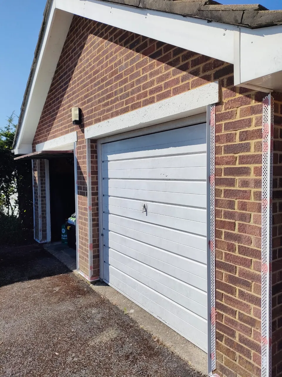 Brick garage front with beads fitted around the doors ready for render