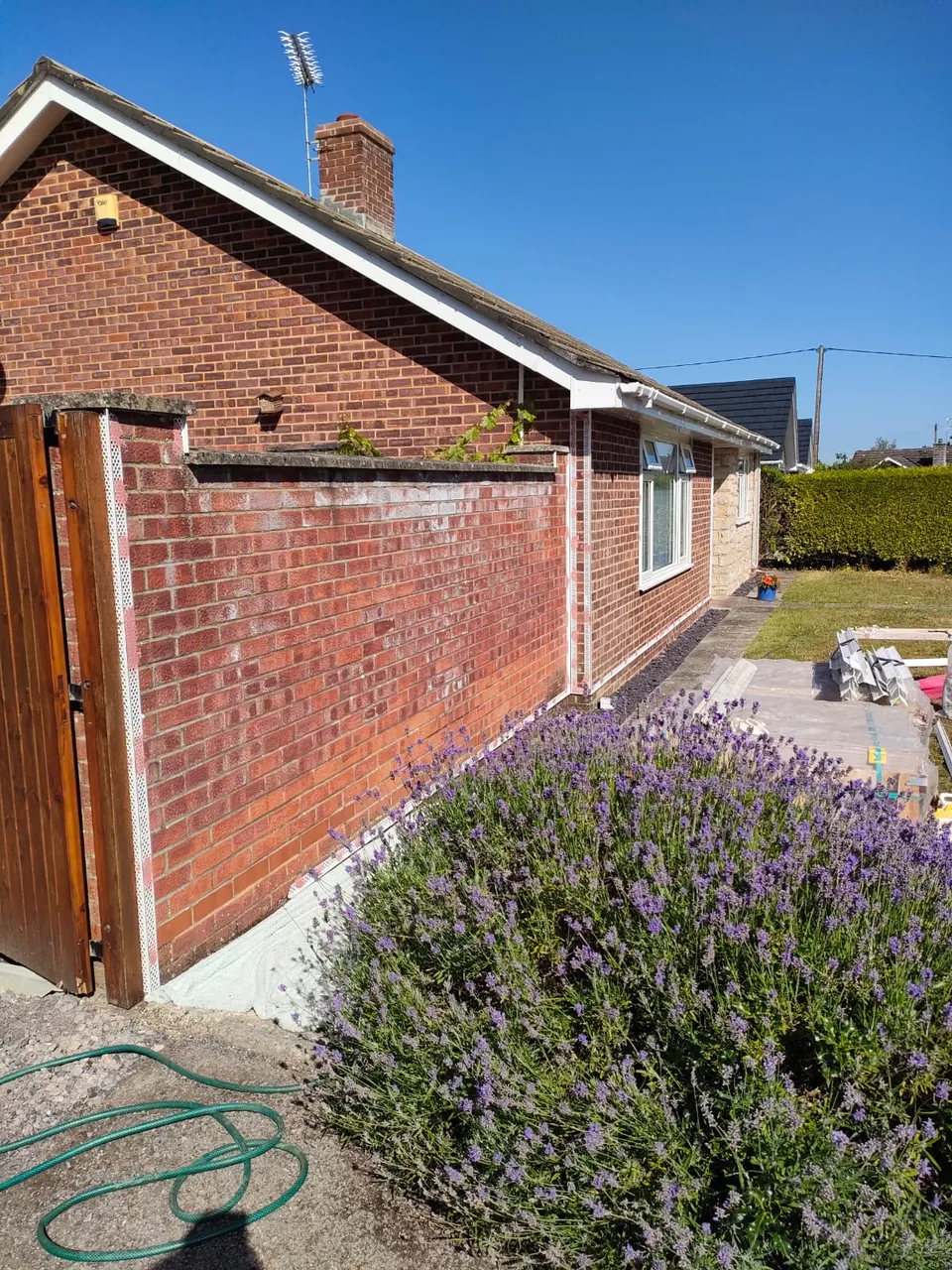 Brick side wall and gate wall of a bungalow with beads fitted ready for render